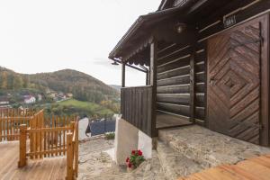 a small building with a wooden door and a bench at Orlí Hnízdo in Štramberk