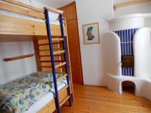 a bedroom with two bunk beds and a ladder at Ferienhaus Grohs in Neumarkt in Steiermark