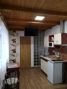 a kitchen with white cabinets and a counter top at Ráday Apartman in Makó