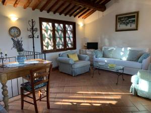 a living room with couches and a table at Il Fienile in San Gimignano