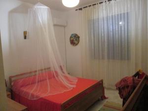 タヴィアーノにあるCasa in macchia mediterraneaのベッドルーム(蚊帳付きのベッド付)