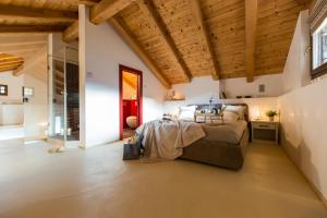 a bedroom with a large bed and wooden ceilings at Wellness Paradise in Ziano di Fiemme