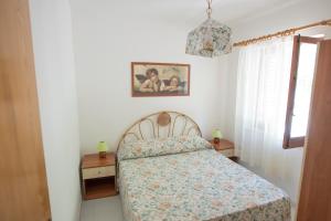 a bedroom with a bed and two night stands at Residence Capo San Marco & Renella in Sciacca
