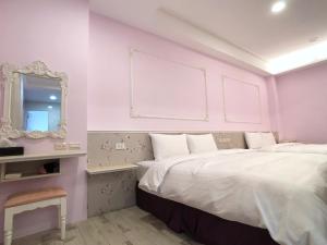 Postel nebo postele na pokoji v ubytování Kenting True Color Hostel