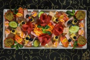 a plate of food with different types of food at Pensiunea Passion in Bucharest +8 photos