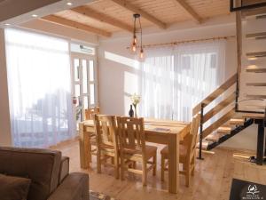 a dining room with a wooden table and chairs at Bergkranc Hotel & Resort in Pale +36 photos