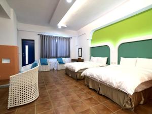 Postel nebo postele na pokoji v ubytování Kenting True Color Hostel