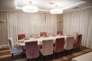 a conference room with a large table and chairs at Hotel Imereti in Kazan