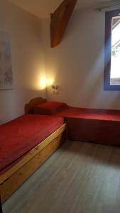 En eller flere senge i et værelse på Apartment in Les Chalets du Galibier 1