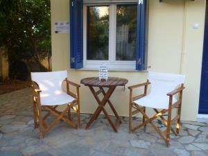 a table and two chairs and a window at Vokamvilia Apartments in Kini +35 photos