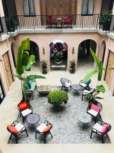 a group of chairs and tables in a courtyard at The Ryad Rayong in Mae Pim