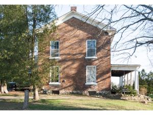 a brick house with white windows and a tree at Culverdene House in Simcoe