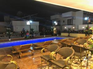 a swimming pool with chairs and a table and a swimming pool at MARKO PASA KONAGİ in Kuşadası