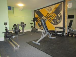 a gym with several tread machines in a room at Sleep Eat Love in Liverpool