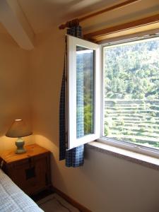 a bedroom with a window with a view at Quinta Casal De Vila Pouca in Cinfães