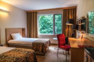 Postel nebo postele na pokoji v ubytování Hotel HP Park Poznań Malta