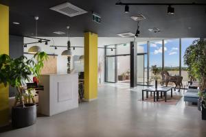 a lobby with potted plants and a table at Hotel Ola - Adults Only in Trogir