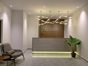 a lobby with a chandelier and chairs in front of a store at Cloud9 Holiday Cottages in Pantai Cenang