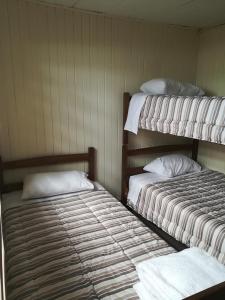 two bunk beds in a room with at Cabañas Arlenne in Valdivia