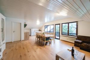 a kitchen and living room with a table and chairs at Ferienwohnungen Am Skilift in Herrischried