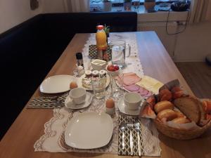 a table with a breakfast of eggs and bread at Böhmerwald Angerholz in Ulrichsberg