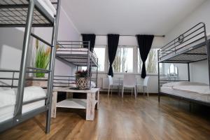 a room with two bunk beds and a table at Elsässer Hostel in Hamburg