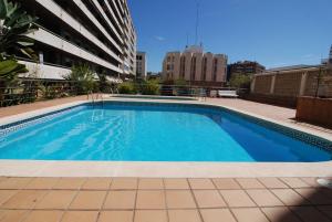 a swimming pool on the roof of a building at Ático Zeus in Tarragona