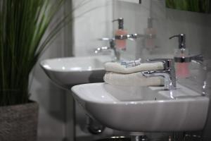 a bathroom with a sink and two towels on a counter at Elsässer Hostel in Hamburg +17 photos