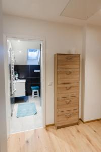 HerrischriedにあるFerienwohnungen Am Skiliftのベッドルーム(ドレッサー付)、バスルームが備わります。