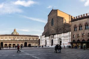 a group of people walking around a city square at SoleLuna Fiera 6 Rooms in Bologna