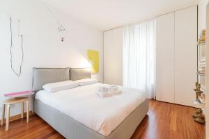 a bedroom with a white bed with towels on it at Scrovegni Design Apartment in Padova