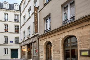 a building with a sign on the side of it at Hôtel de Notre-Dame in Paris