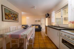 eine Küche mit einem Tisch und einem Tischtuch darauf in der Unterkunft Residencial Kelly Cristina in Bombinhas