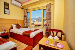 A bed or beds in a room at Hotel Grand Holiday