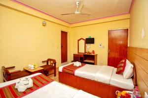 A bed or beds in a room at Hotel Grand Holiday