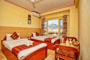 A bed or beds in a room at Hotel Grand Holiday