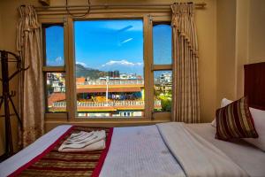 A bed or beds in a room at Hotel Grand Holiday
