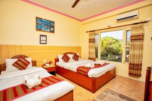 A bed or beds in a room at Hotel Grand Holiday