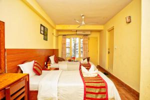 A bed or beds in a room at Hotel Grand Holiday