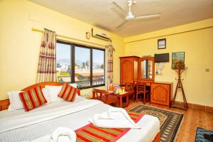 A bed or beds in a room at Hotel Grand Holiday