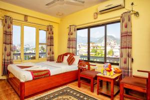 A bed or beds in a room at Hotel Grand Holiday