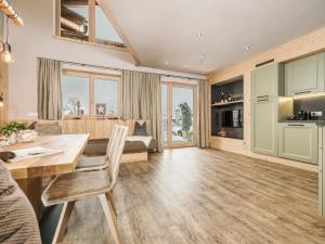 a living room with a dining table and a couch at Zillertaler Hofchalets in Stumm +44 photos