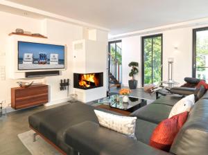 a living room with a couch and a fireplace at Paradise Cloud***** in Binz