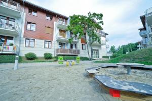 an empty playground in front of a building at Grand Apartments - Neptun Park. in Gdańsk