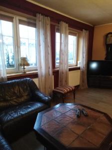 a living room with a couch and a coffee table at Zajazd pod Różą in Zielona Góra