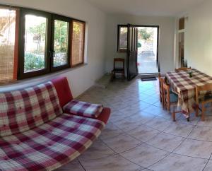 a living room with a couch and a table at Apartmani Sandro in Ivan Dolac