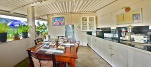 a kitchen with a wooden table and chairs in it at Villa Hikka 08 in Hikkaduwa