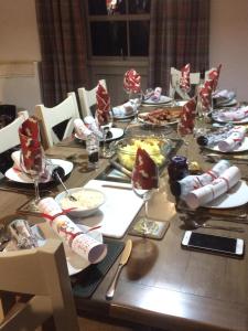 a long table with food and wine glasses on it at Nellies Shed, Wolds Way Holiday Cottages, 3 bed spacious cottage in Cottingham