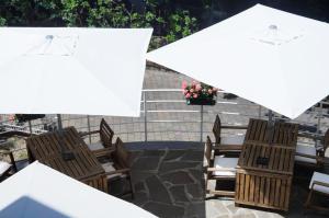 a group of chairs and umbrellas on a patio at Hotel Esperia in Genoa