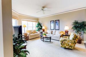 a living room with two couches and a tv at Hampton Place II in Hilton Head Island